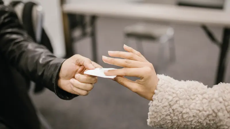 Échange d'une carte de visite entre deux mains